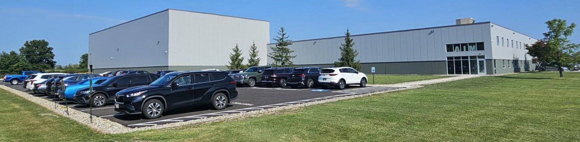 Industrial building with parked cars outside.