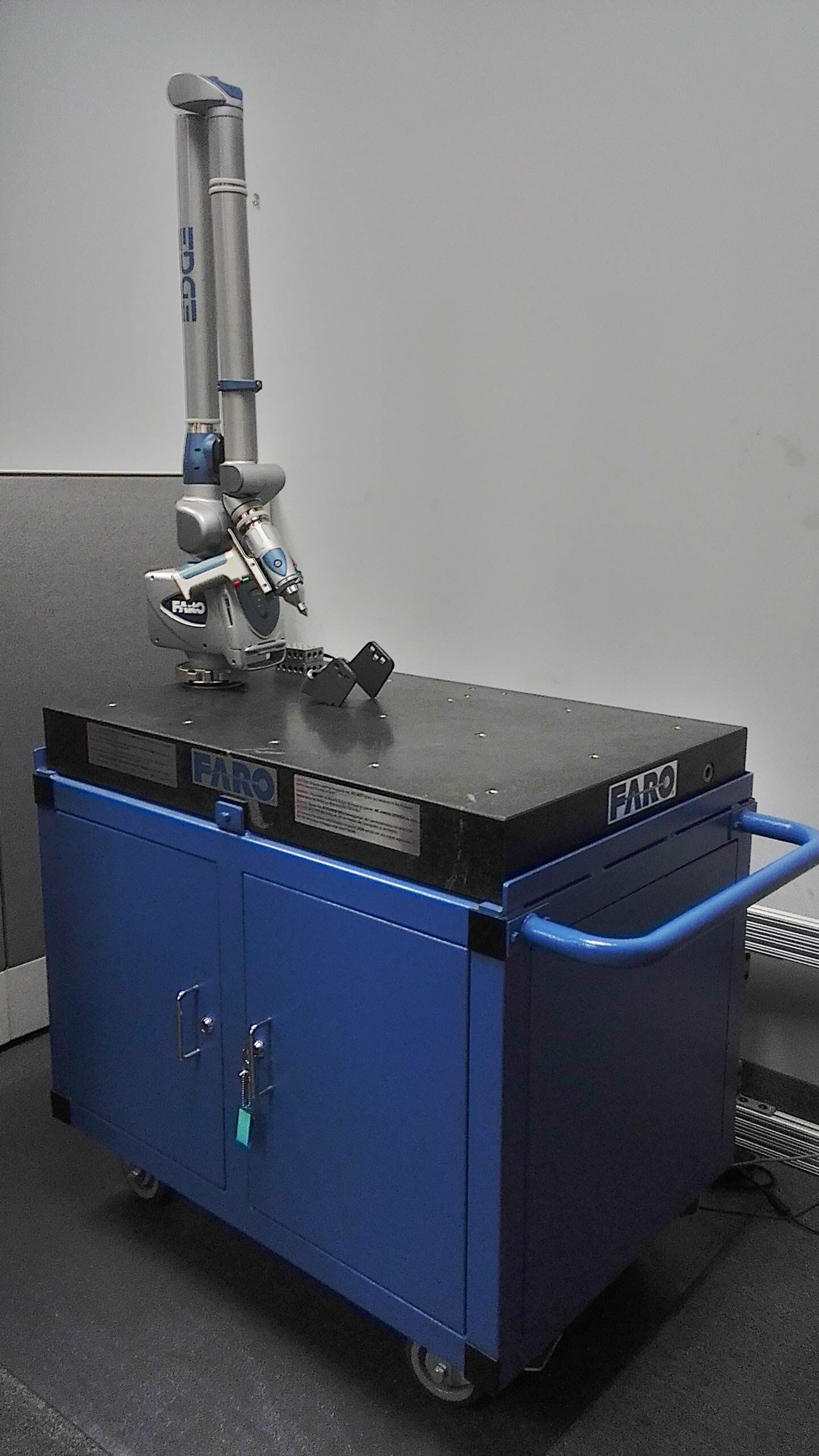 A blue cabinet with a microscope on top of it.